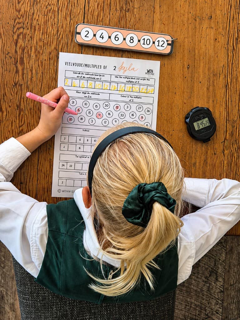 Learner reading a Play Mathematics workbook